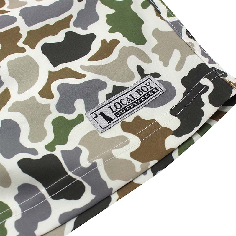 Close up of the Local Boy Volley Shorts in Localflage camo. The front features a logo sewn on patch.